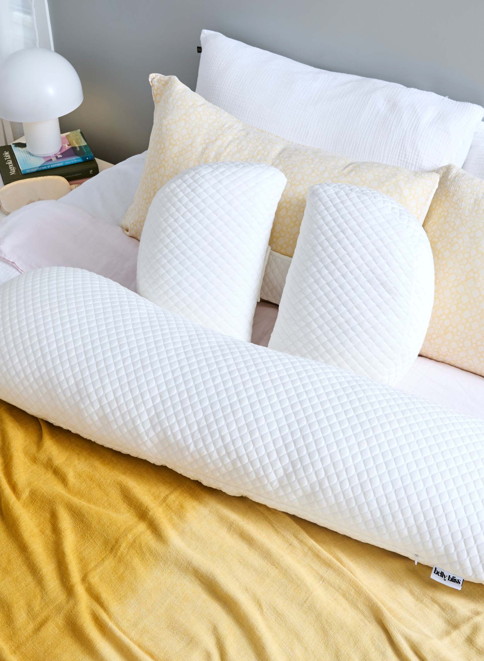 White pillows on a bed with yellow bedding