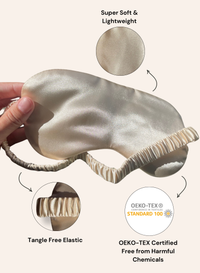 A satin sleep mask being held by a hand, shown with feature callouts including 'Super Soft & Lightweight,' 'Tangle Free Elastic,' and an OEKO-TEX certification badge on a warm beige background.