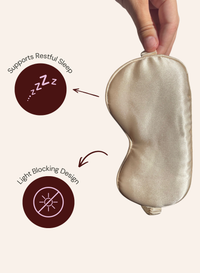 A satin sleep mask held by a hand against a light beige background, with two callout graphics on the left highlighting features: 'Supports Restful Sleep' with a ZZZ icon and 'Light Blocking Design' with a sun icon.