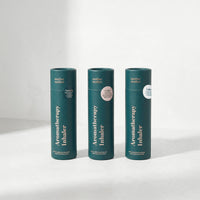 Three green aromatherapy inhaler containers on a white background