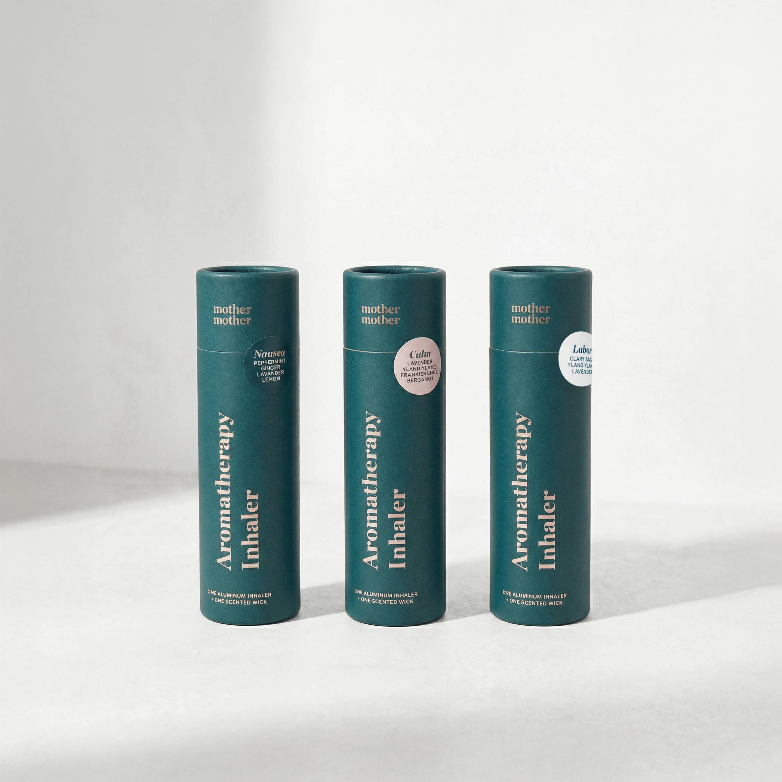 Three green aromatherapy inhaler containers on a white background