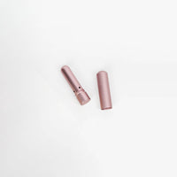 Two pink cylindrical objects on a white background