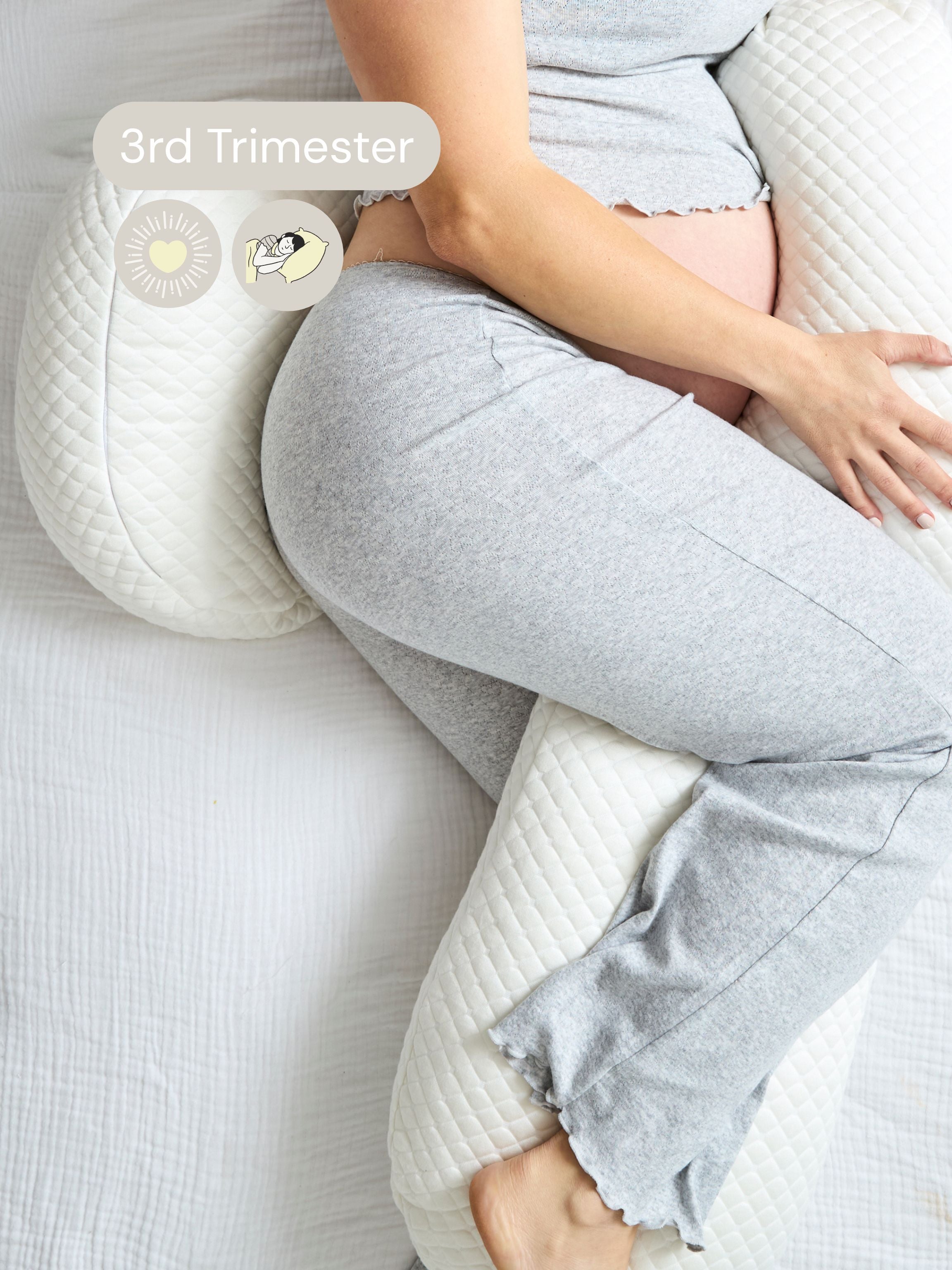 woman in 3rd trimester using pregnancy pillow