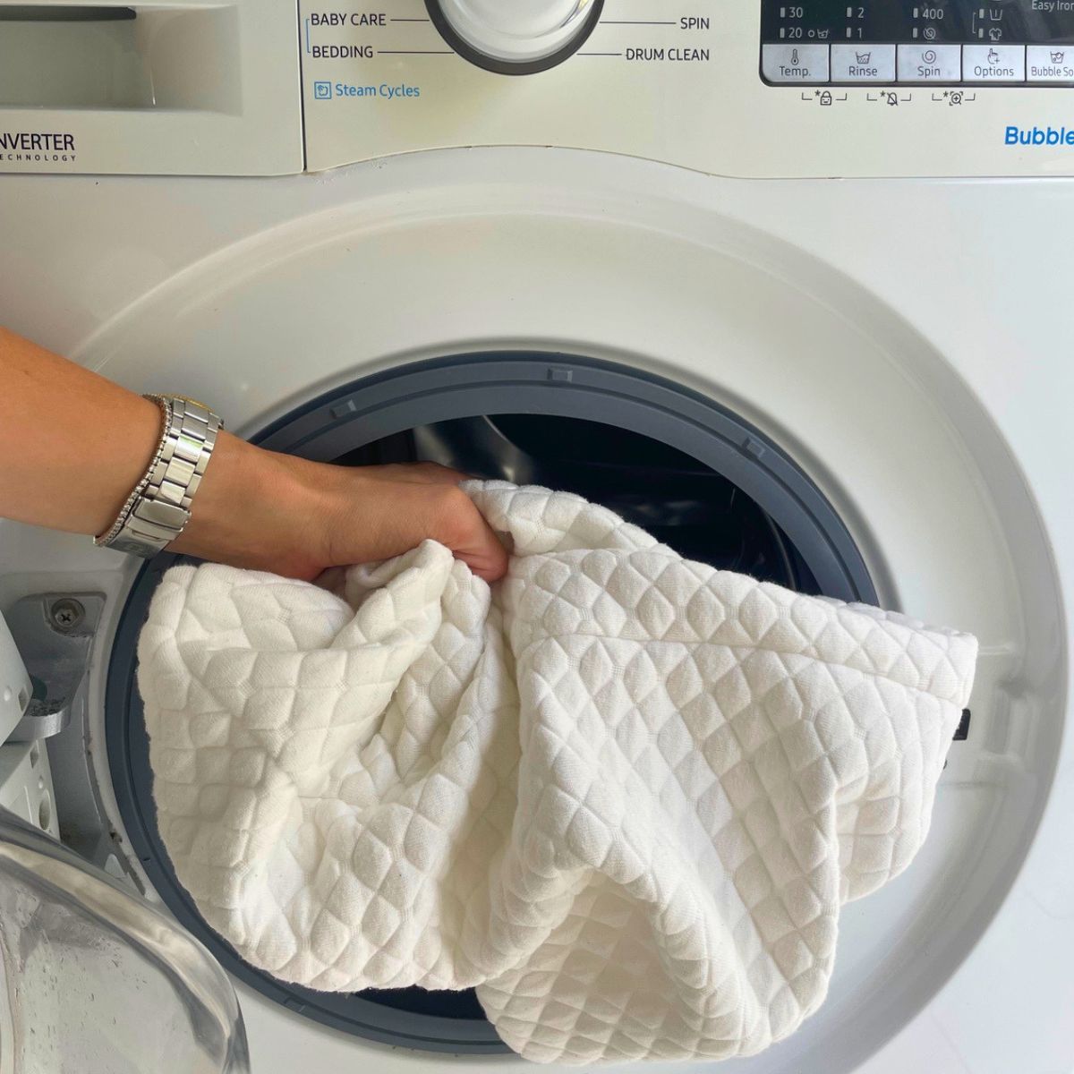 Person placing covers into a washing machine